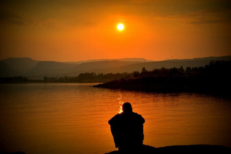man reflecting at lake's edge representing enneagram and fear